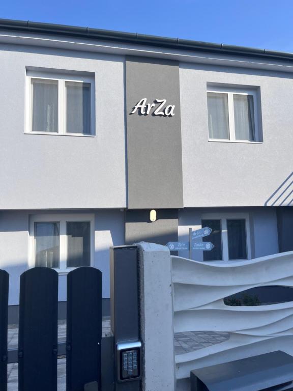 a building with a sign on the side of it at ArZa Sóstó Apartman in Nyíregyháza