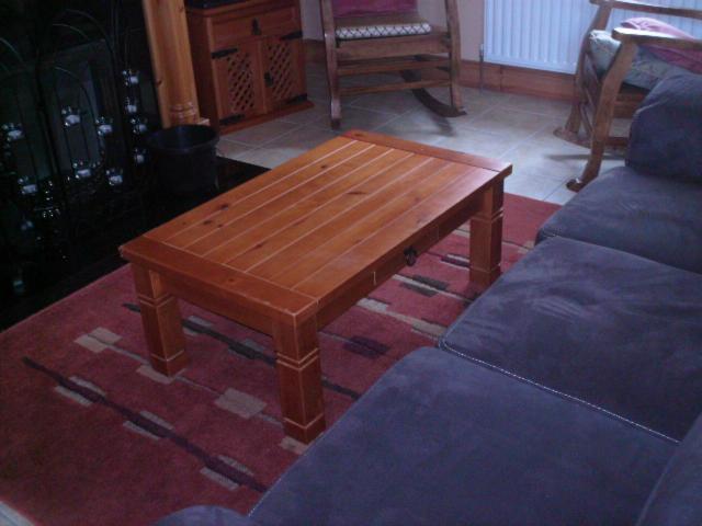 a wooden coffee table in a living room with a couch at Ocean View Doogort in Doogort