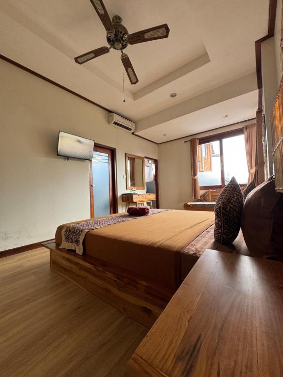 Postel nebo postele na pokoji v ubytování Raditya House