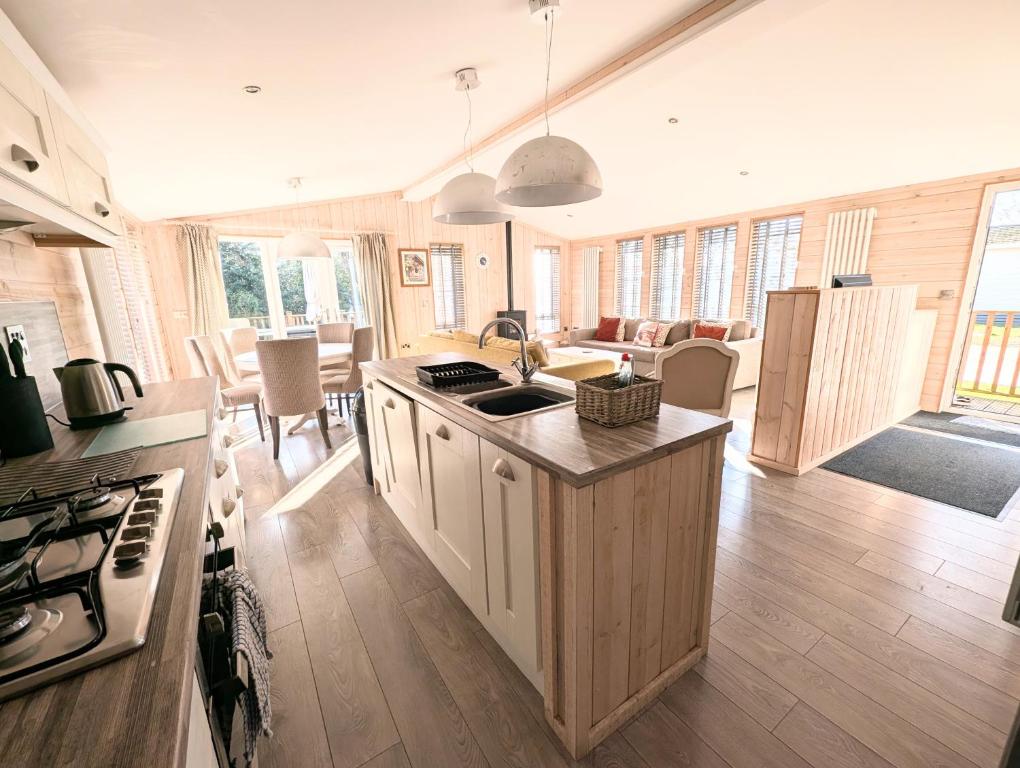 a kitchen with an island in the middle of a room at 1 or 2 bedroom Hot tub Lodges in North Walsham