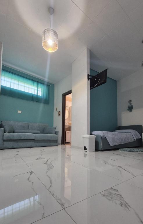 a living room with a couch and a bed at La piccola Dimora di Sara in Termoli