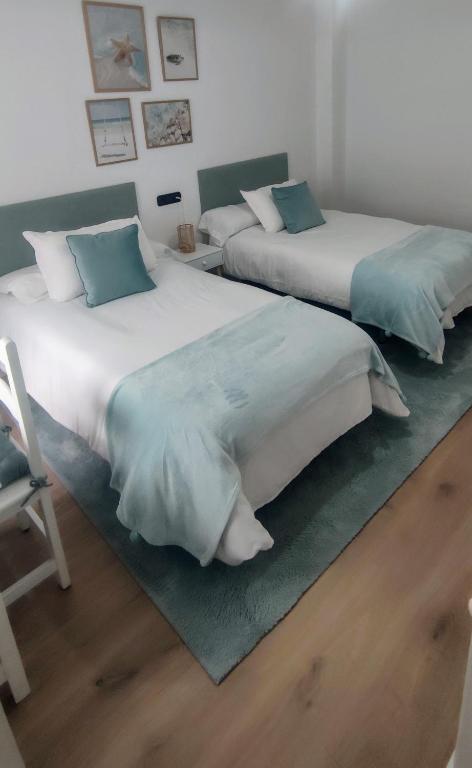 Кровать или кровати в номере Apartamento Illa Salvora, Portonovo
