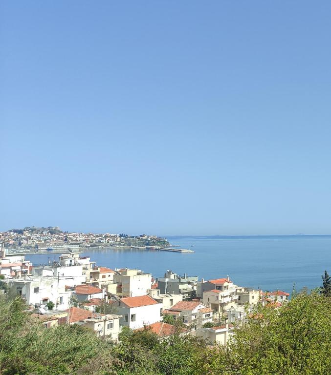 a group of buildings on a hill near the water at Anatoli Kavala in Kavála