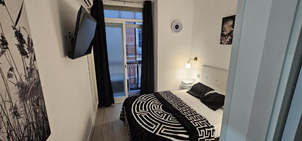 Cama o camas de una habitación en Habitaciones Gran Via