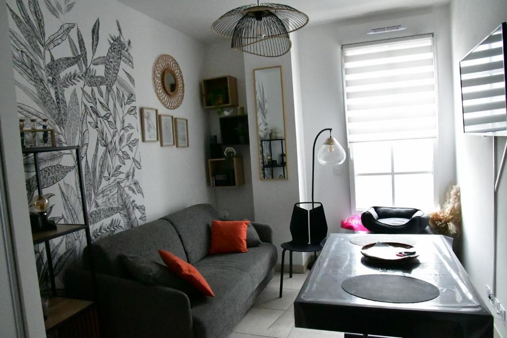 un soggiorno con un divano e un tavolo di Studio neuf à louer à Dinard 3 nuits minimum a Dinard