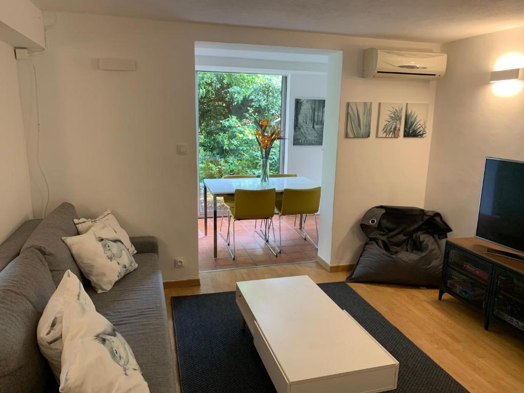 a living room with a couch and a table at T2 en rez-de-jardin en plein coeur de la Londe les Maures in La Londe-les-Maures