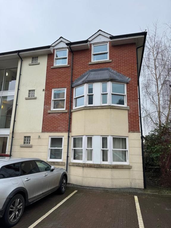 a car parked in front of a brick building at Modern, sleeps 6, rural market town, Llani in Llanidloes