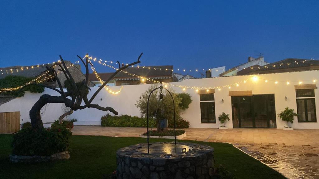 a house with a statue in front of it with lights at Alquería de Tajarja in Tajarja