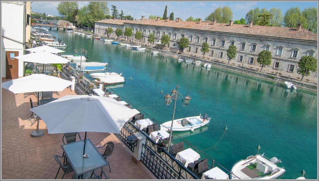 a view of a marina with boats in the water at Acqua Verde Appartamenti in Peschiera del Garda