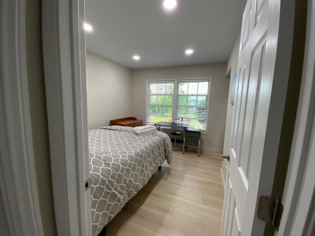 a bedroom with a bed and a desk and a window at 1 bedroom In a quiet neighborhood near the Main Street- Room A in Rowland Heights