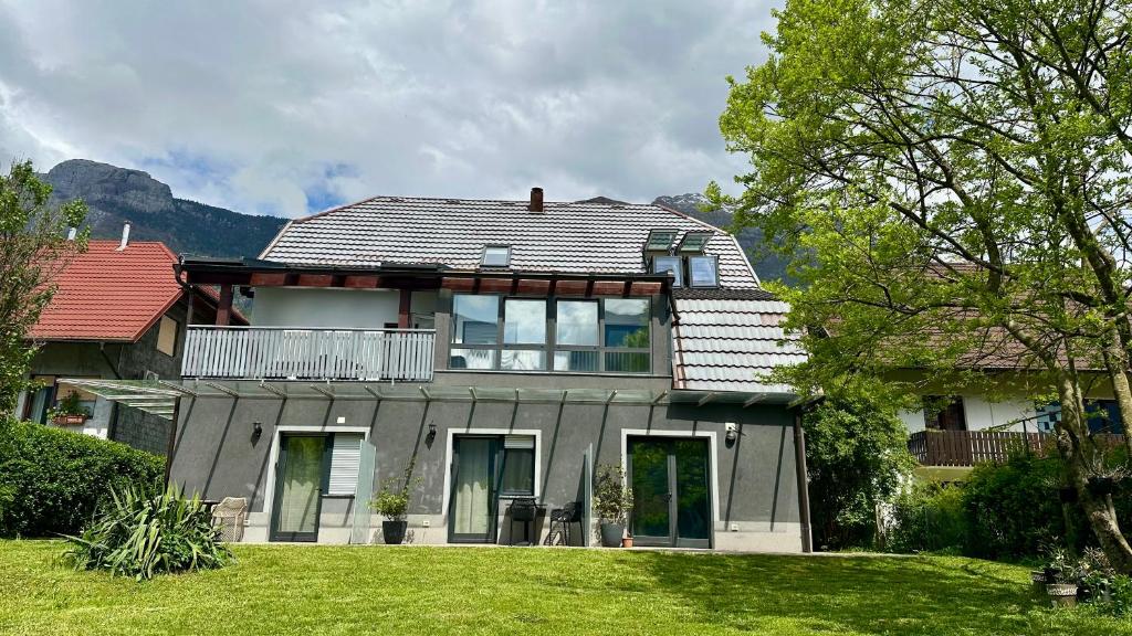 a house with a large yard in front of it at Two Panorama Apartments in Bovec