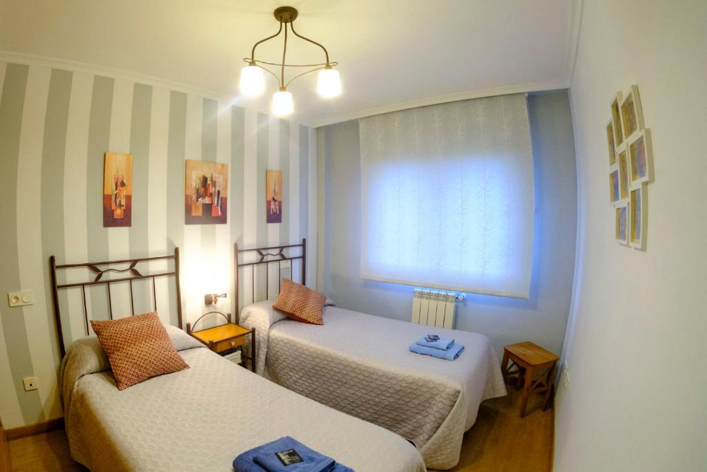 A bed or beds in a room at Apartamento Sella y Mar - VUT12AS