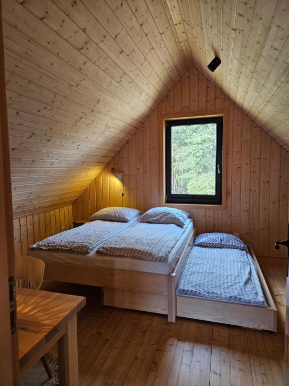 Postel nebo postele na pokoji v ubytování Domki nad Kukówkiem