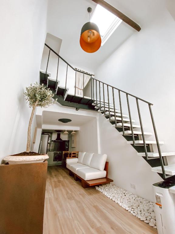 a living room with a staircase and a white couch at Casa SaloYa - Sintra Historical Center in Sintra