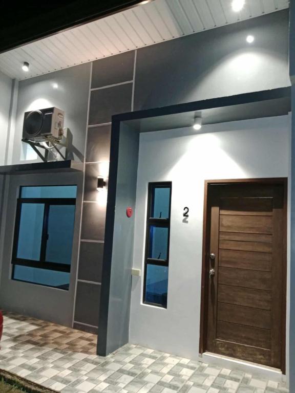 a house with a door and a tv on the wall at BMR Apartment-Unit 2 in Dipolog