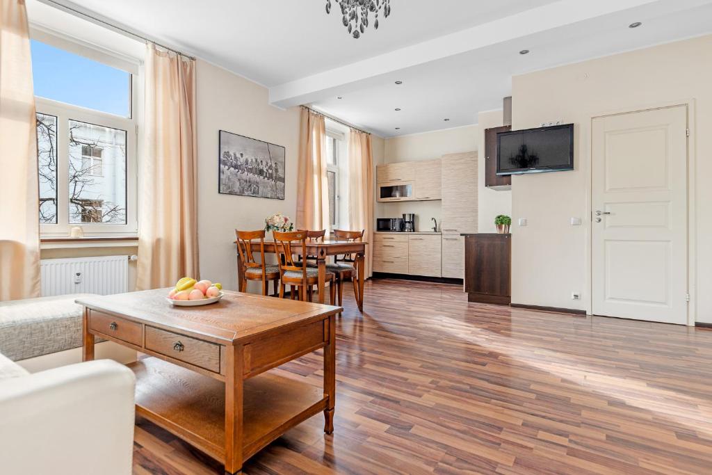 a living room with a couch and a table at Compass apartment in Tallinn