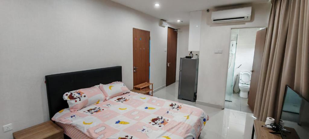 a bedroom with a bed with a pink comforter at Stunning View III Kozi square in Kuching