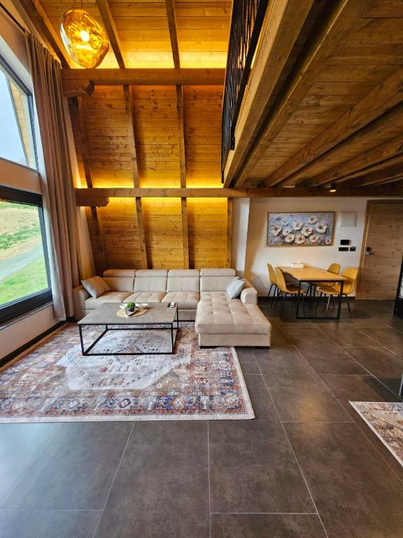 a large living room with a couch and a table at Luxury Villa Mašić -Apartment Ali in Bugojno