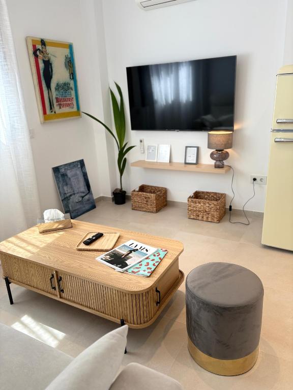 a living room with a coffee table and a flat screen tv at ICEBERG LUXURY DUNEs Free Private Parking in Tarifa