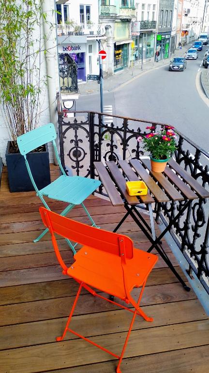 a colorful chair and a table on a deck at Pou-Spa in Spa