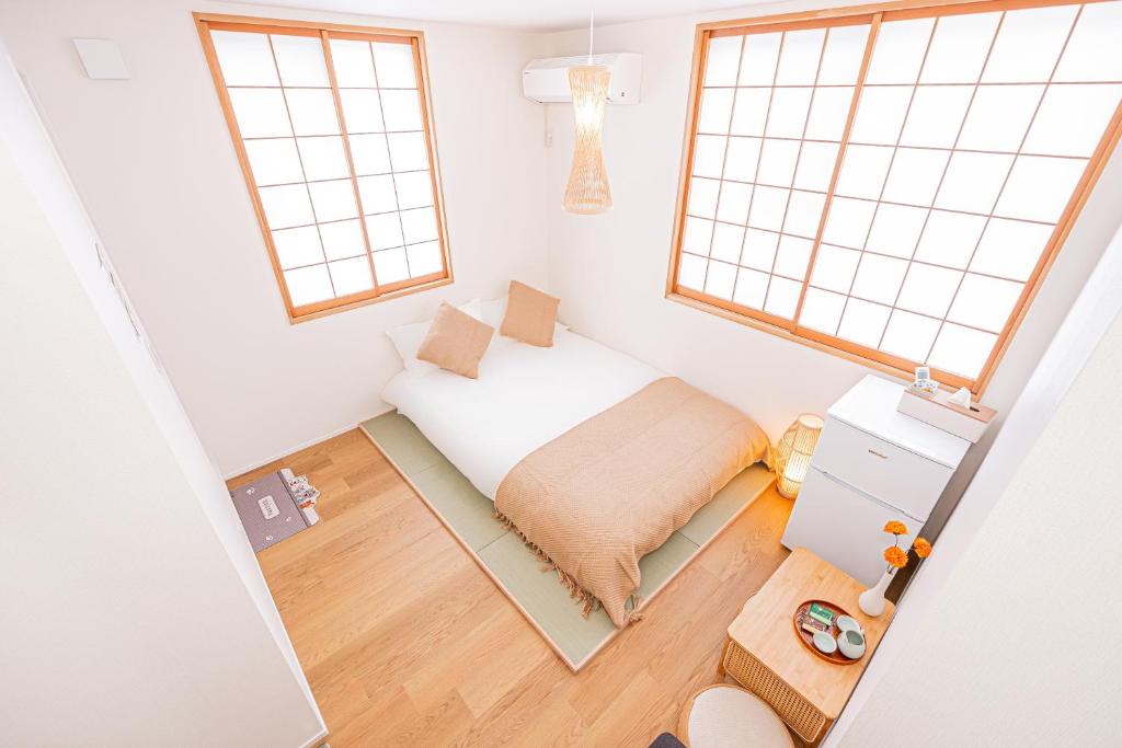 Postel nebo postele na pokoji v ubytování Kamakura no Nikki