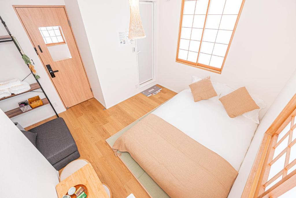 Postel nebo postele na pokoji v ubytování Kamakura no Nikki