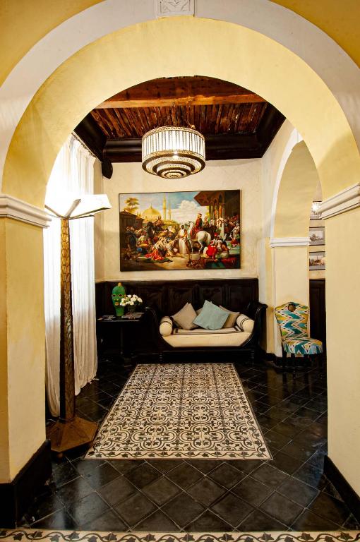 a living room with an archway with a couch at Riad Callas in Essaouira