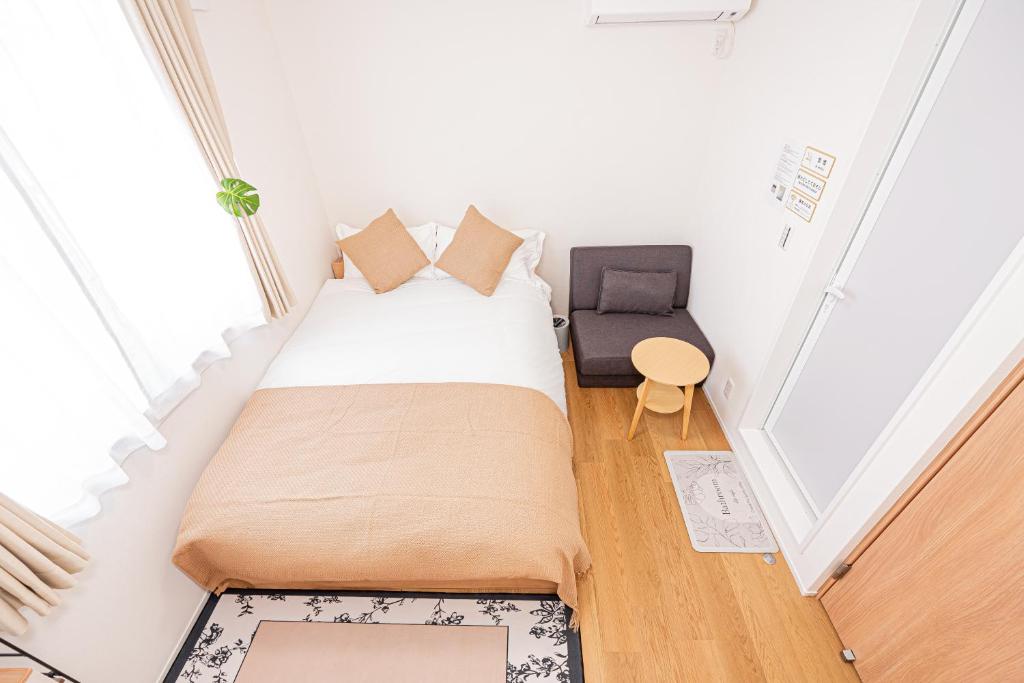 Postel nebo postele na pokoji v ubytování Kamakura no Nikki