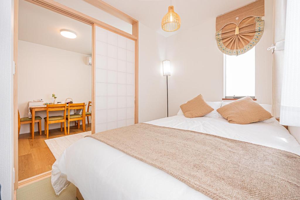 Postel nebo postele na pokoji v ubytování Kamakura no Nikki