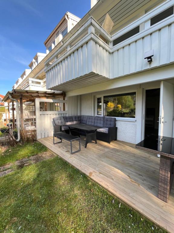 a wooden deck with a bench on a house at Apartment , wooded area lake, sea ,golf and shopping malls Askim domarings väg 154 in Askim