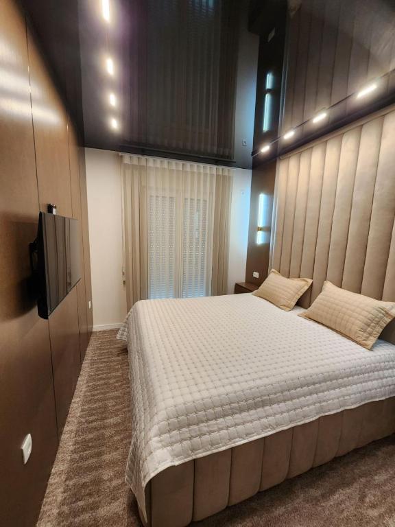 Postel nebo postele na pokoji v ubytování Harmony Apartments