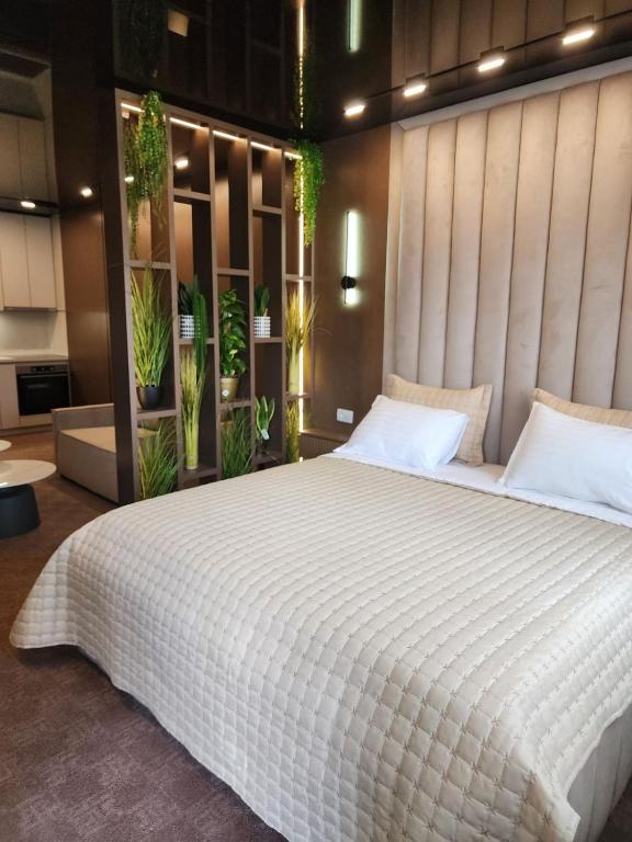 Postel nebo postele na pokoji v ubytování Harmony Apartments