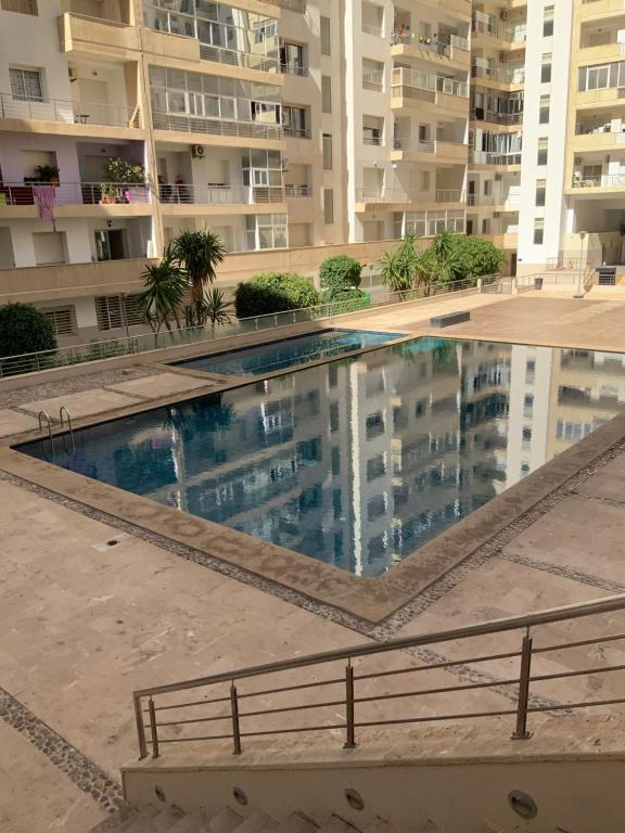 an empty swimming pool in front of a building at Ecrin Moderne Islan a Agadir in Agadir