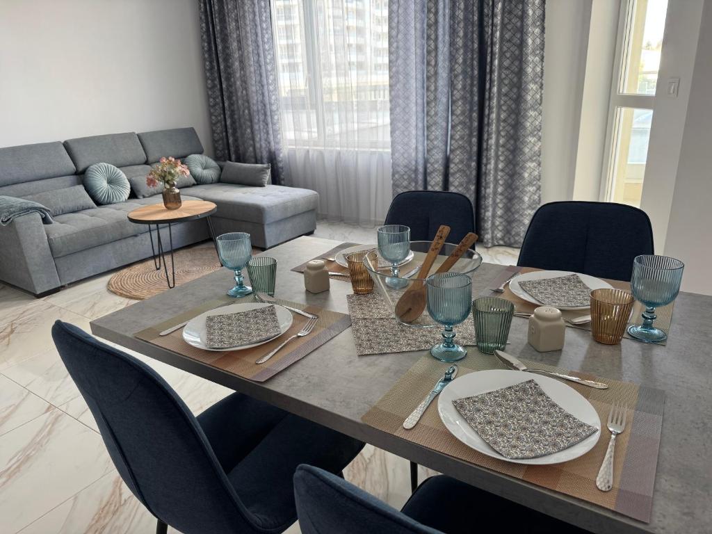 a dining table and chairs in a living room at Central Park 7 in Burgas City