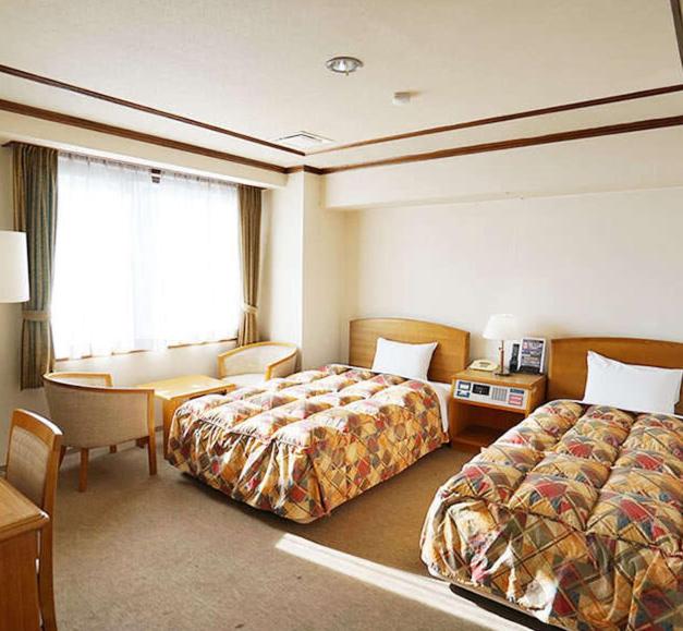 Postel nebo postele na pokoji v ubytování 寝屋川トレンドホテル