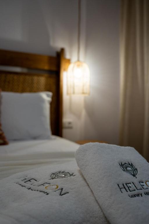 a hotel room with a bed with a towel on it at Heleon Luxury Apartments in Parga