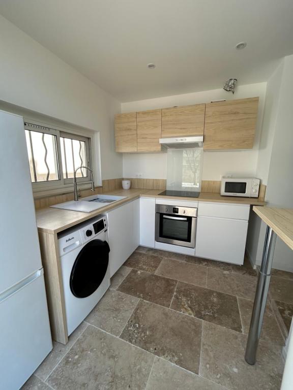 Il comprend une cuisine équipée d'une cuisinière et d'un lave-vaisselle. dans l'établissement Le Brasilia, à Six-Fours-les-Plages