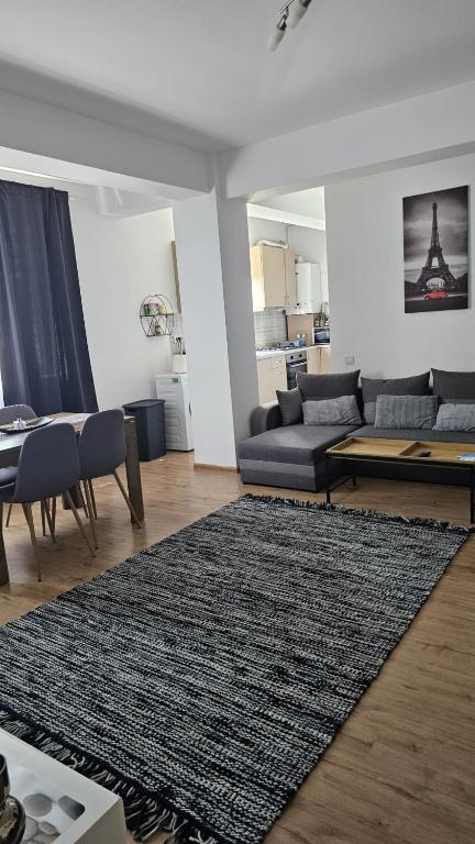 a living room with a couch and a rug at Doxa Airport Otopeni in Otopeni