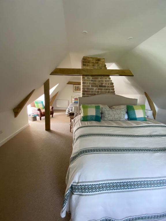 a bedroom with a large bed in a attic at The Garden House in Dewlish