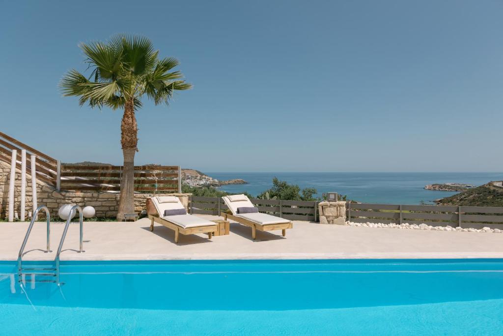 a pool with two lounge chairs and a palm tree at Villa Aldea Bali - Sea View - Private Pool in Vlikhádha