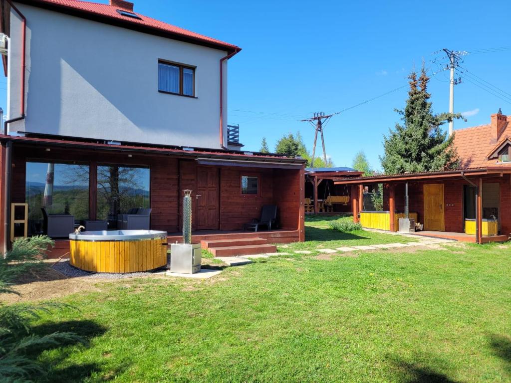 a house with a hot tub in the yard at Apartement u Jędrusia w ogrodzie in Żywiec