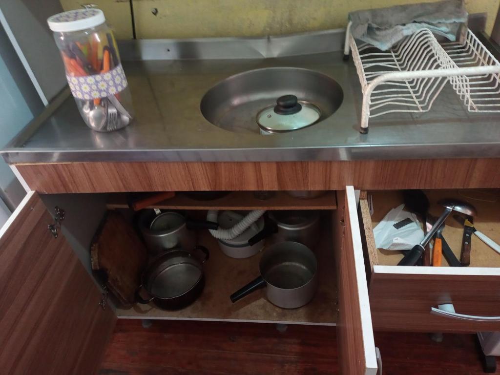 a kitchen counter with a sink and some pots and pans at Se sinta em casa nessas férias in Igrejinha