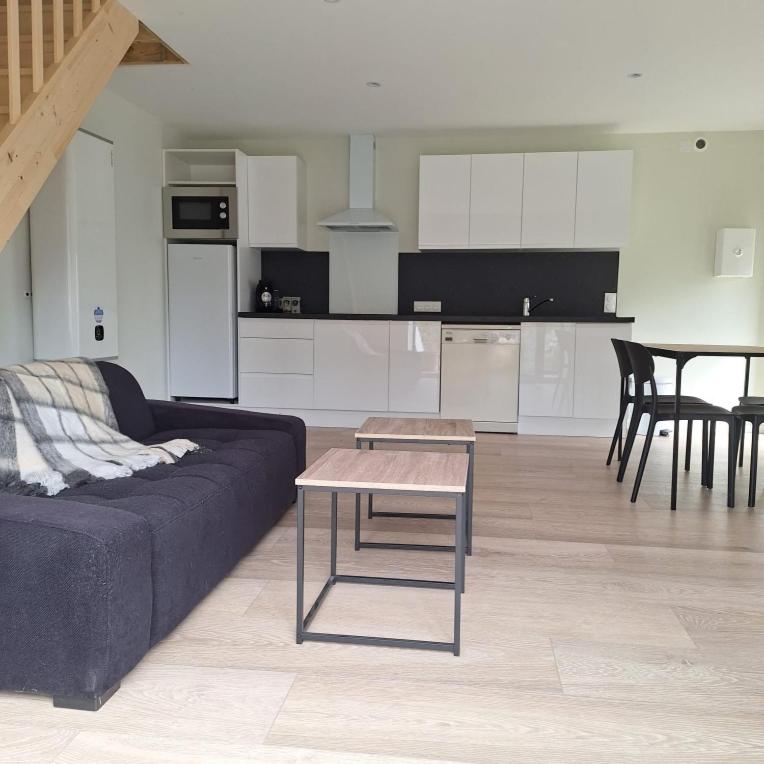 a living room with a couch and a table at Ma Petite Maison in Belz