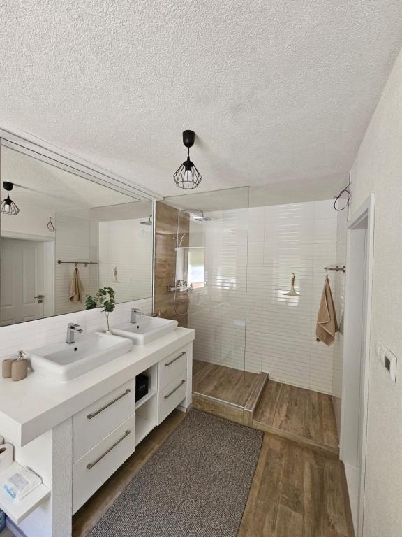 a bathroom with two sinks and a large mirror at Ubytovanie Hronec in Hronec