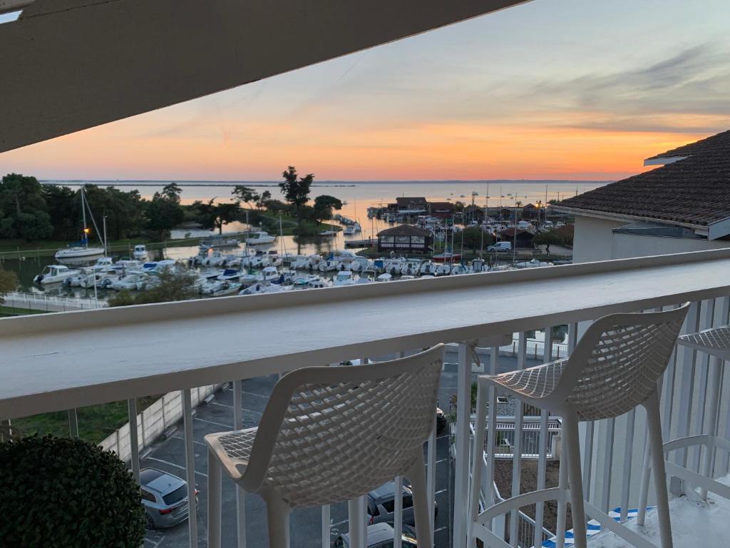 - deux chaises sur un balcon avec vue sur le port de plaisance dans l'établissement Loft vue Bassin Arcachon Marina de Cassy, à Lanton