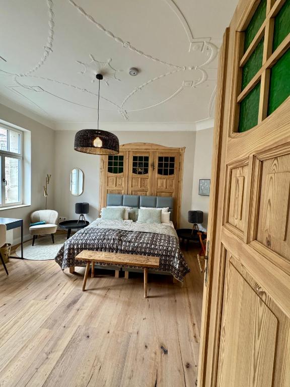 a bedroom with a bed with a wooden floor at EngelHaus Fürth in Fürth