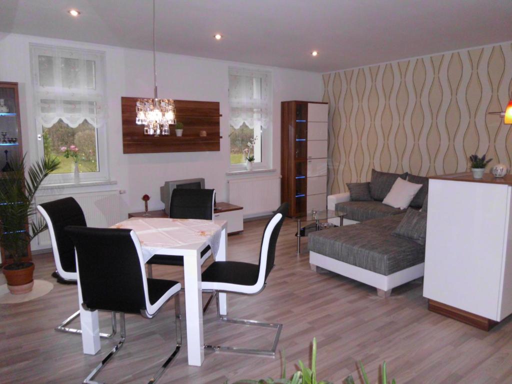 a living room with a table and chairs and a couch at Apartment Leucht in Ziegenrück