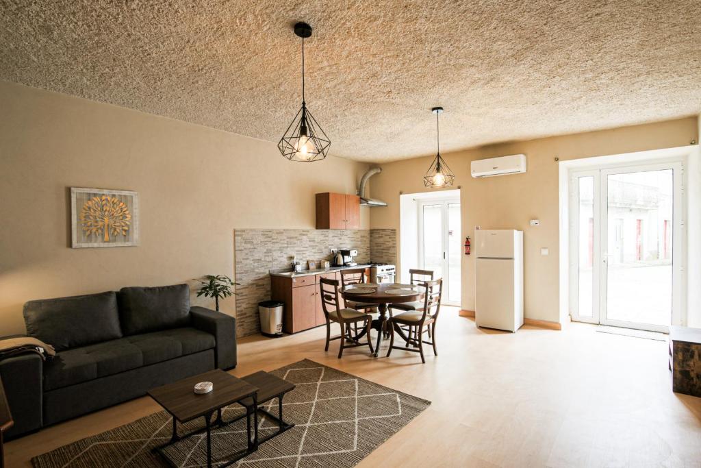 a living room with a couch and a table at Casa Pinheiro in Pinheiro de Coja