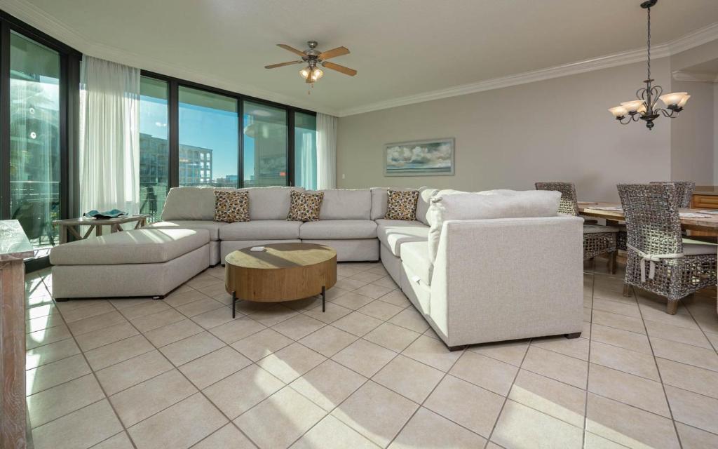 a living room with a couch and a table at Lighthouse on the Bay 2109 condo in Orange Beach