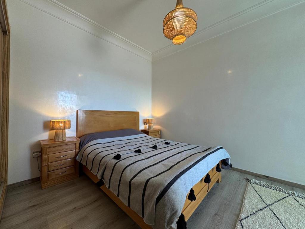 Ένα ή περισσότερα κρεβάτια σε δωμάτιο στο Appartement Miramar vue panoramique Mohammedia